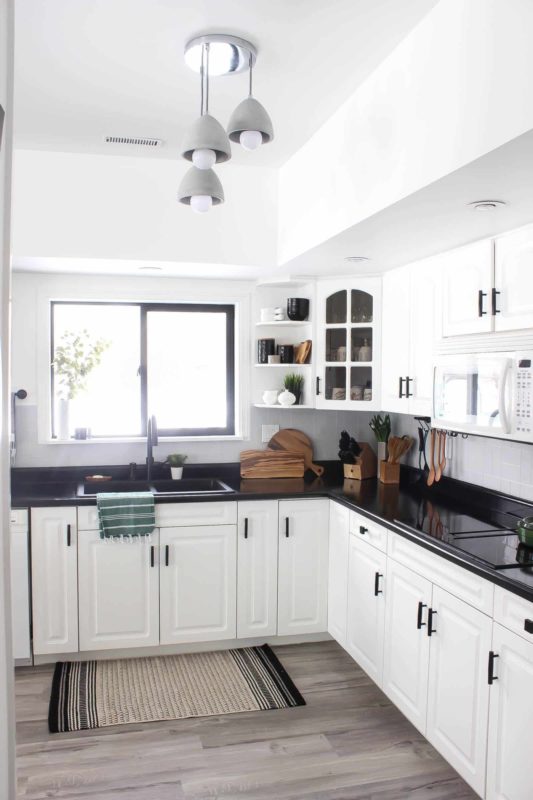 muebles de cocina blancos con encimeras negras